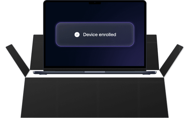 A Mac laptop screen showing a glowing “Device enrolled” confirmation banner, indicating successful macOS enrollment.