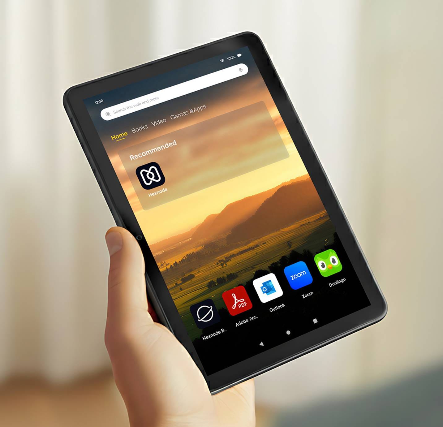 Tablet in managed kiosk mode showing Hexnode and business apps.